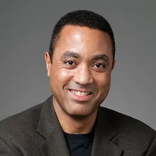 Джон Макуортер logo